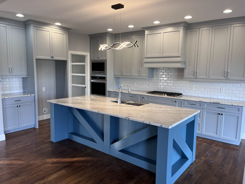 Kitchen with custom Crossbuck Island refuge blue by Tideline Cabinetry